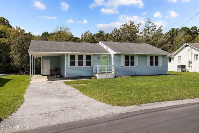 ranch-style home with central AC, a front yard, and a carport