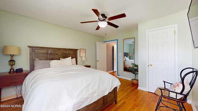 bedroom featuring ceiling fan and light hardwood / wood-style flooring