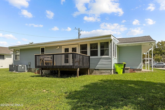 back of property featuring a wooden deck, a yard, and central AC