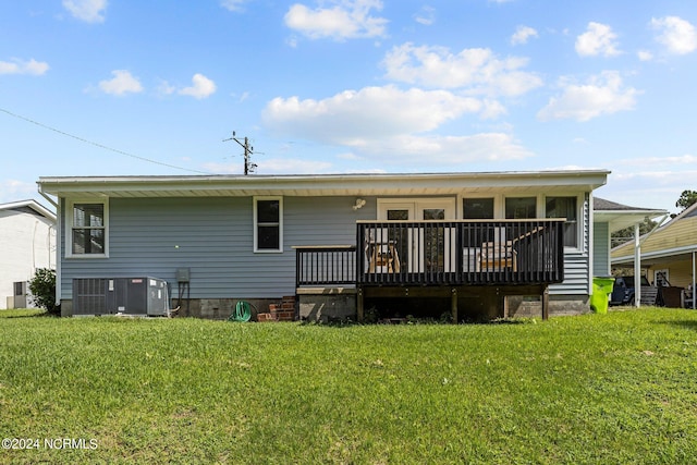 back of house with cooling unit, a deck, and a yard