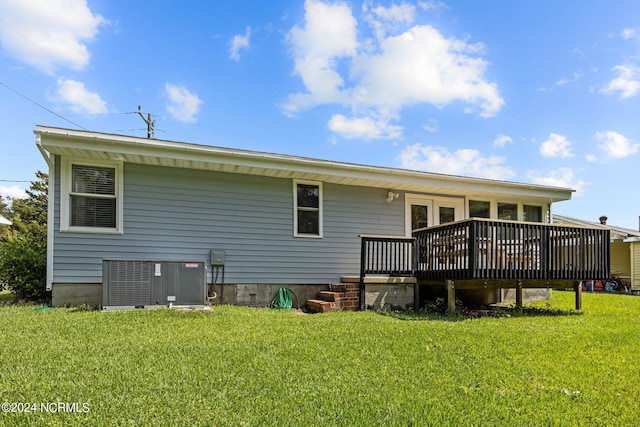 back of house with a lawn and a deck