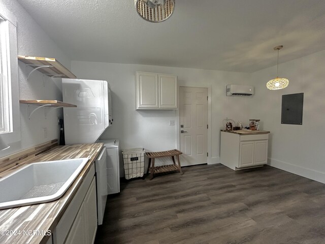 kitchen featuring electric panel, decorative light fixtures, dark hardwood / wood-style flooring, and wood counters