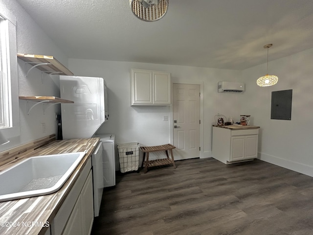 kitchen with stacked washer / dryer, open shelves, dark wood-type flooring, electric panel, and a sink