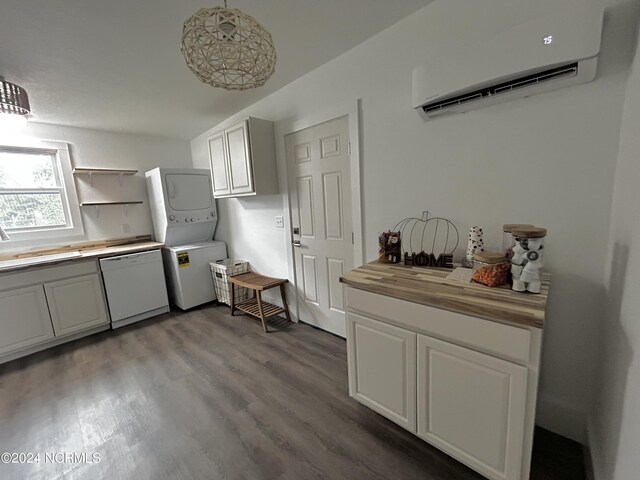 kitchen with stacked washer and clothes dryer, white dishwasher, a wall mounted air conditioner, white cabinetry, and wooden counters