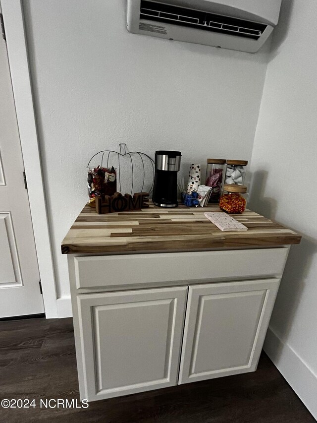 room details featuring hardwood / wood-style flooring and a wall mounted air conditioner