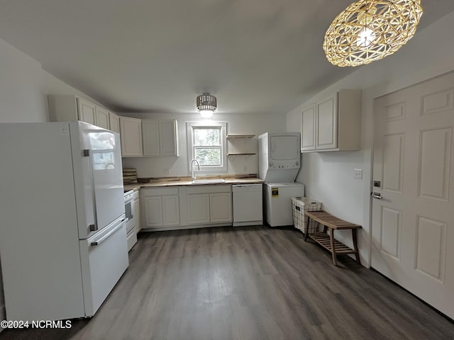 kitchen featuring light countertops, stacked washer and dryer, wood finished floors, white appliances, and open shelves