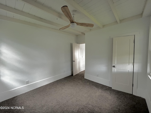 unfurnished bedroom featuring beam ceiling, a ceiling fan, carpet floors, wooden ceiling, and baseboards