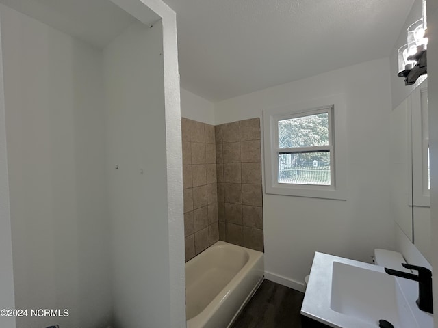 104 Charles St, Hertford, NC 27944 - full bath featuring vanity, wood finished floors, baseboards, and shower / tub combination