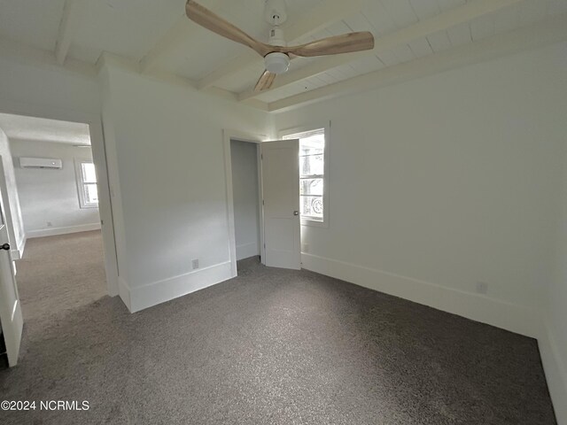 unfurnished bedroom with multiple windows, beam ceiling, and ceiling fan