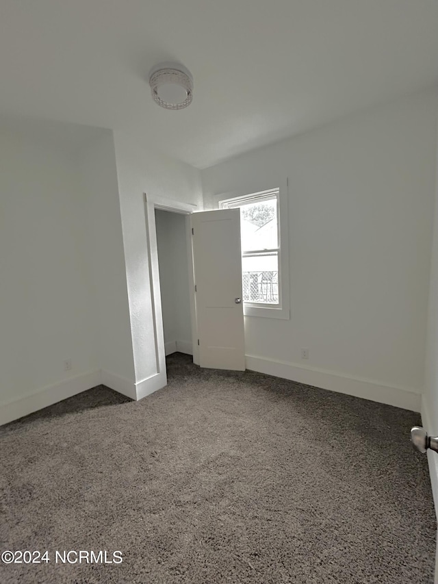 empty room with speckled floor and baseboards