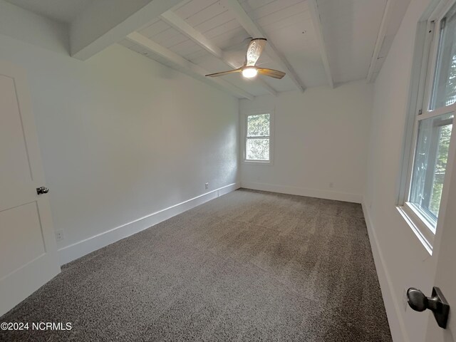 carpeted spare room featuring beam ceiling and ceiling fan