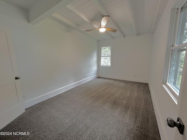 spare room with beam ceiling, a ceiling fan, and baseboards