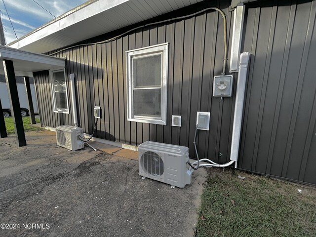 view of side of home with ac unit