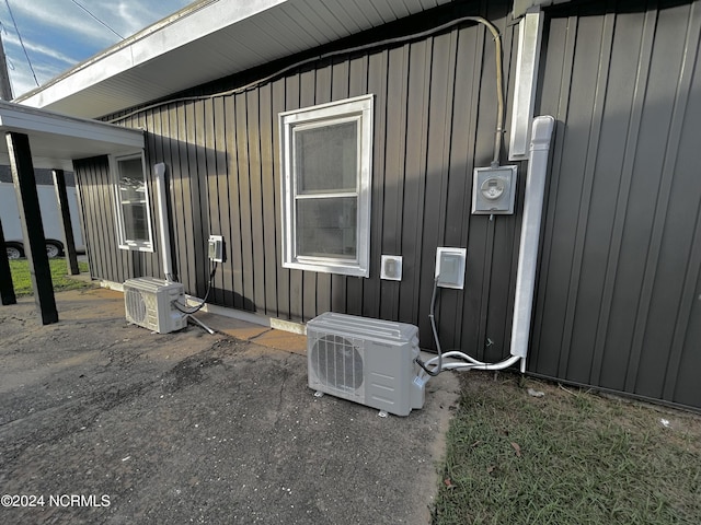 view of home's exterior with board and batten siding and ac unit