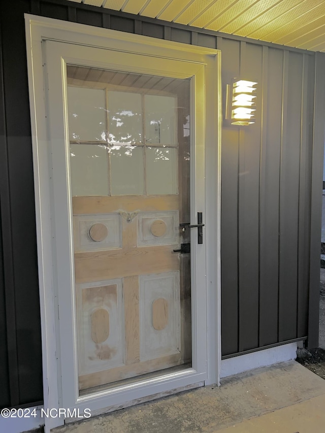 property entrance featuring board and batten siding