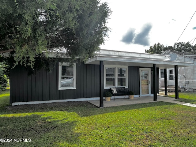 view of front of house featuring a porch, board and batten siding, and a yard