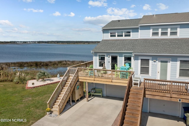 view of front of property with a garage and a water view