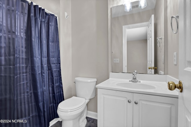 bathroom with walk in shower, vanity, and toilet