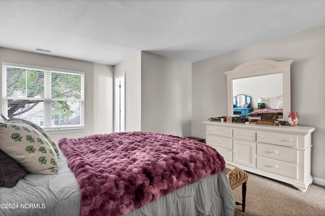 bedroom featuring light colored carpet