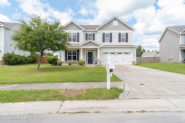 view of front of home with a front yard and a garage