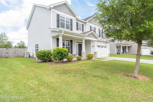 view of front of property featuring central air condition unit, a front yard, and a garage