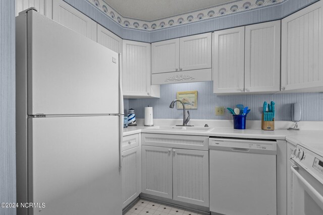 kitchen with sink and white appliances