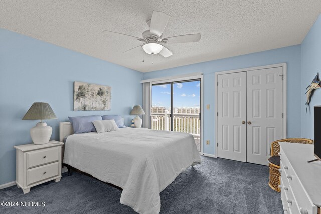 bedroom featuring ceiling fan, access to outside, a textured ceiling, and dark carpet