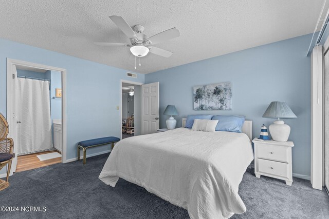 carpeted bedroom featuring a textured ceiling and ceiling fan