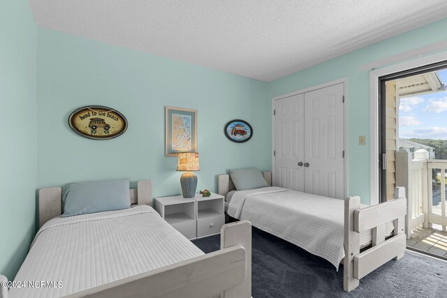 bedroom with a closet, carpet flooring, and a textured ceiling