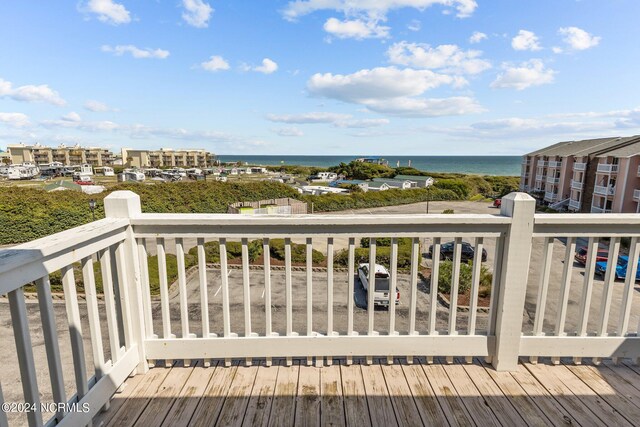 wooden terrace featuring a water view