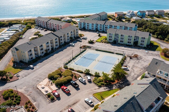 drone / aerial view featuring a water view and a beach view