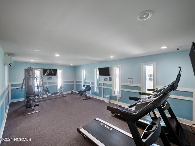 exercise room featuring a wall unit AC