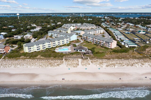 aerial view with a water view and a beach view