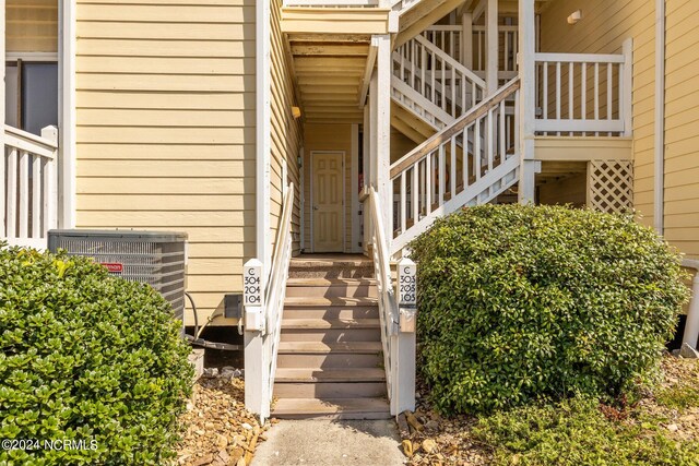 entrance to property featuring cooling unit