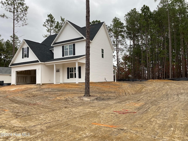 view of front of home featuring covered porch and a garage