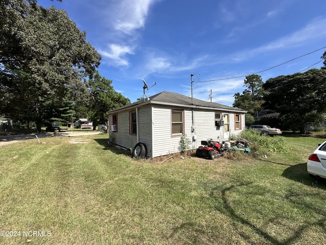 view of side of home featuring a lawn