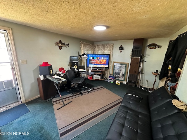 carpeted home office featuring a textured ceiling