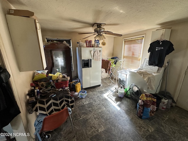 interior space featuring white fridge with ice dispenser, tile patterned floors, a textured ceiling, and a ceiling fan