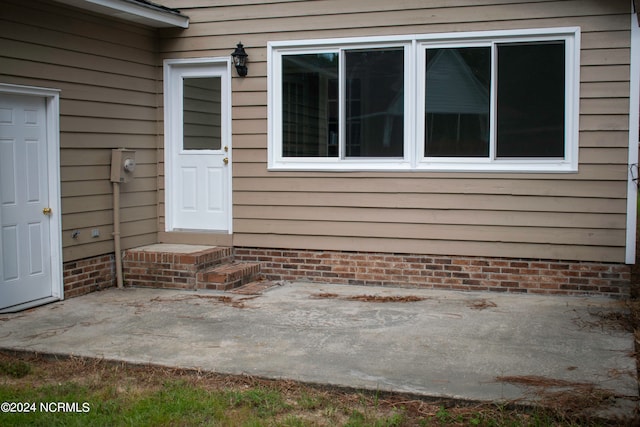 doorway to property with a patio area