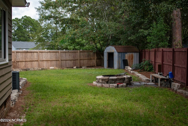 view of yard with a shed and central AC