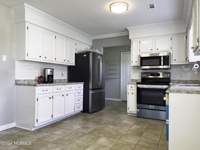 kitchen with appliances with stainless steel finishes, crown molding, decorative backsplash, and white cabinetry