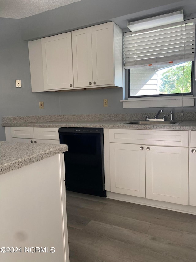 kitchen featuring white cabinets, sink, black dishwasher, dark wood-type flooring, and a textured ceiling