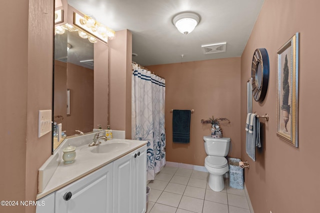 bathroom with walk in shower, vanity, toilet, and tile patterned floors