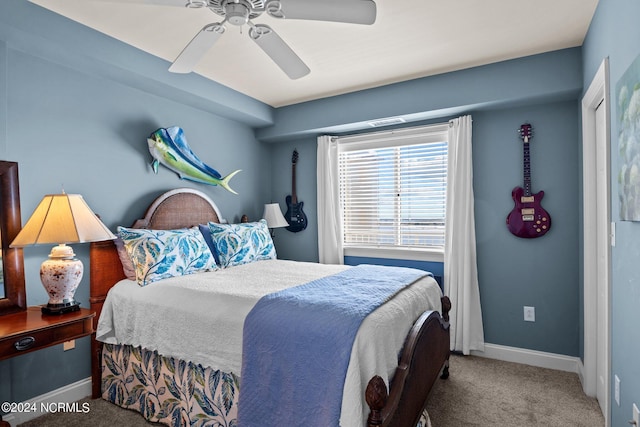 carpeted bedroom with a ceiling fan and baseboards