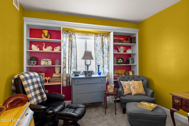 living area featuring baseboards, visible vents, and carpet floors