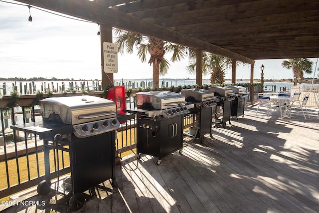 wooden terrace with a pergola and a grill