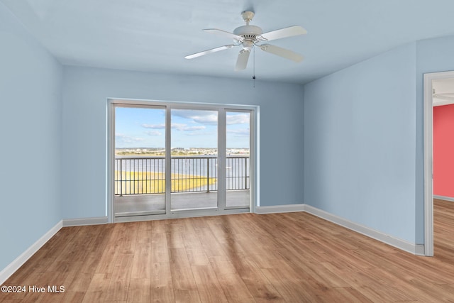 unfurnished room with baseboards, light wood finished floors, and ceiling fan