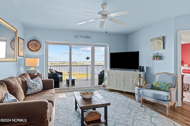 living area with wood finished floors and ceiling fan