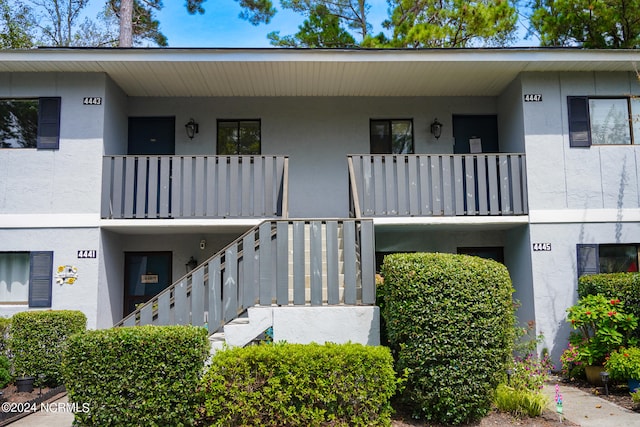 exterior space featuring a balcony and stucco siding