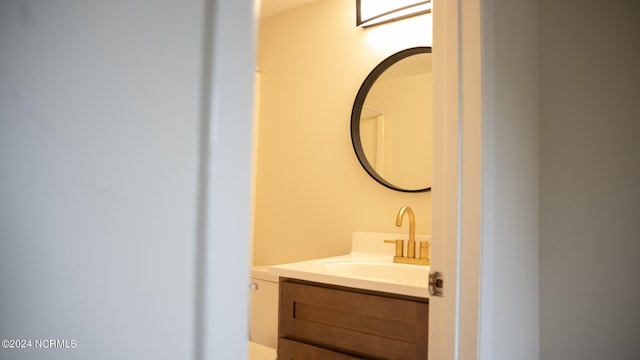 bathroom featuring toilet and vanity